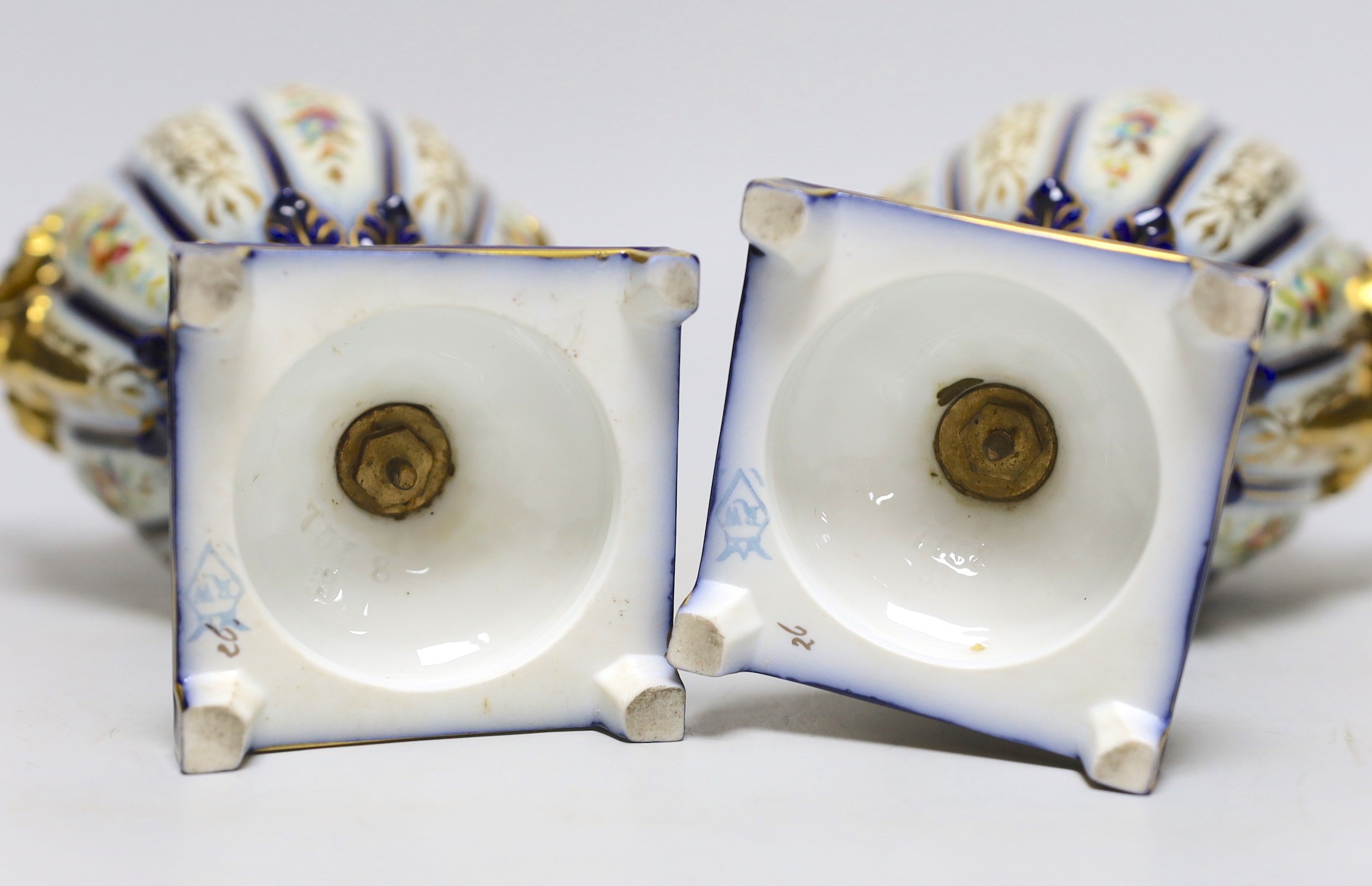 A pair of 19th century continental porcelain gilt and floral urns and covers, 29cms high